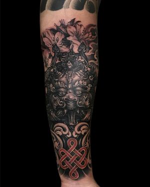 Experience Avi's intricate blend of floral elements, intricate patterns, and striking mask motif in this stunning Japanese forearm tattoo design.