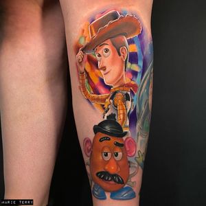 Get inked with a quirky new school tattoo of Woody the cowboy and a potato in anime style by talented artist Marie Terry on your lower leg.