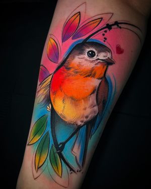 Express your love for nature with a captivating watercolor forearm tattoo by Cloto.tattoos. Features a bird, heart, and leaf motif.