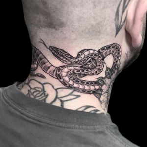 Classic snake motif tattoo on the neck by Letitia Mortimer, showcasing timeless traditional style.
