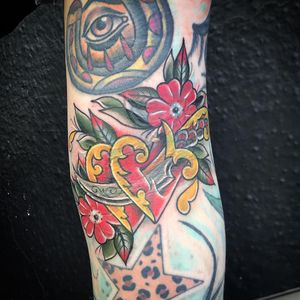 Get a stunning neo-traditional tattoo on your arm featuring a flower, heart, and dagger, expertly executed by tattoo artist Matthew Ono.