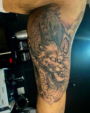 Explore the beauty of traditional Japanese style with this stunning black and gray dragon tattoo by the talented artist Frankie Brown.