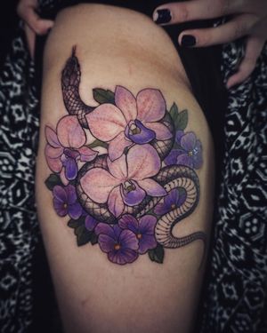 Let Aygul's skillful hands bring this beautiful snake and flower design to life on your upper leg with vibrant watercolor style.