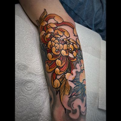 Get inked with a stunning chrysanthemum design by the talented artist Lamat. Embrace the beauty of nature on your forearm in this neo-traditional style.
