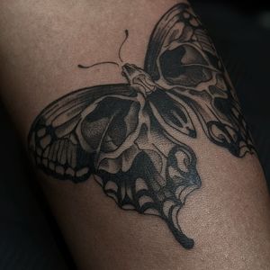 Check out this stunning black and gray tattoo design featuring a butterfly and skull motif, done by tattoo artist Luca Salzano.