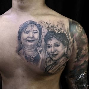 Get a stunning black and gray tattoo of a woman with elegant earrings and collar by the talented artist Avi on your chest.