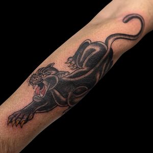 Capture the power and strength of a traditional panther tattoo on your forearm by Letitia Mortimer.