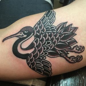 Adorn your upper arm with a striking blackwork heron tattoo by the talented artist Kiko Lopes. Embrace the beauty of nature.