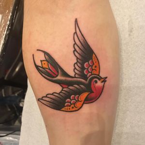 Beautiful traditional style bird tattoo by artist Matthew Ono, perfect for anyone looking for a classic design on their lower leg.