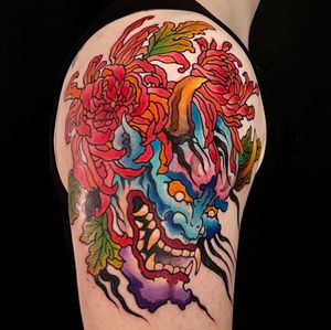 Get a stunning illustrative tattoo on your upper arm by artist Kiko Lopes. This unique design features a combination of flowers, devils, and horns.