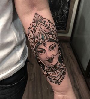 Unique blackwork forearm tattoo featuring a captivating mandala design with elements of a woman, piercing, kali, filigree, and an eye. Expertly done by tattoo artist Avi.