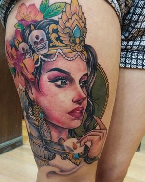 Beautiful illustrative piece on upper leg by Avi featuring a woman with earrings and crown.