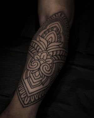 Adorn your forearm with intricate patterns and delicate lines by Lamat, expert in fine line ornamental tattoos.