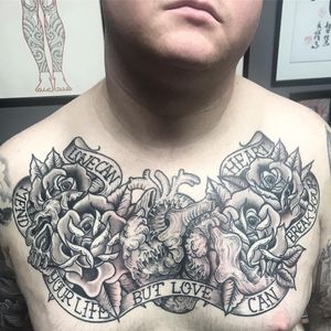 Stunning black and gray traditional style chest tattoo featuring a beautiful flower rose and inspirational quote, done by Matthew Ono.