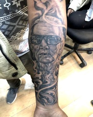 Capture the beauty and elegance of a woman wearing glasses in this stunning black and gray forearm tattoo by Avi. Intricate filigree details add a touch of sophistication to this illustrative design.