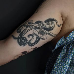 Get inked with a stunning black and gray octopus design on your upper arm by the talented artist Luca Salzano. Dive into the depths of creativity with this unique piece.