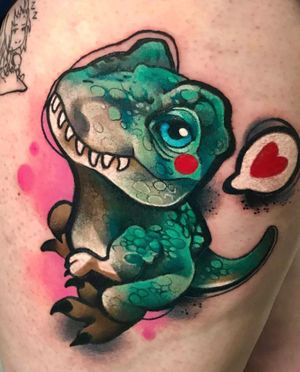 Vibrant watercolor design of a dino and heart on upper leg by Cloto.tattoos. Unique and eye-catching!