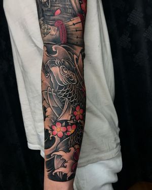 Avi's illustrative masterpiece featuring intricate fish and delicate cherry blossom designs, perfect for a striking sleeve tattoo.
