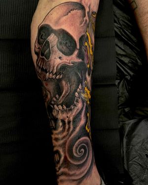 Get a stunning black and gray/blackwork tattoo of a skull and waves on your lower leg by artist Fernando Joergensen.