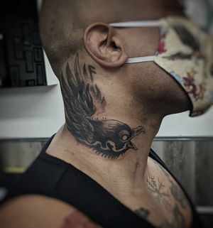 Elegant black and gray bird tattoo expertly done on the neck by the talented artist Luca Salzano.