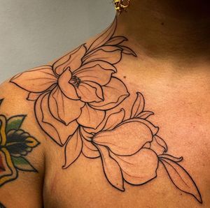 Elegant flower design on chest by talented artist Edyta, featuring intricate fine line work for a stunning result.