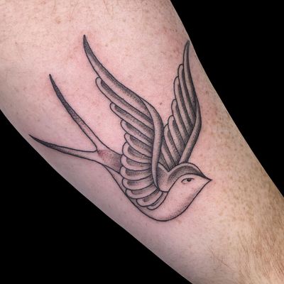 Elegant black and gray bird design by Letitia Mortimer, perfect for those who seek a minimalist yet detailed tattoo.