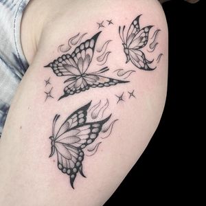 Beautiful black and gray butterfly tattoo on the upper arm, created by Letitia Mortimer, showcasing elegance and beauty.