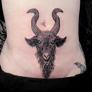 Detailed and elegant goat design by Fernando Joergensen, perfect for adding a touch of sophistication to your stomach ink. Expertly executed in fine line black and gray style.