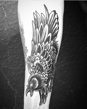 Masterfully blended black and gray eagle design by Matthew Ono, perfect for a bold and powerful statement on your forearm.