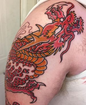 Get a striking illustrative tattoo of a Japanese dragon on your upper arm by the talented artist Kiko Lopes.