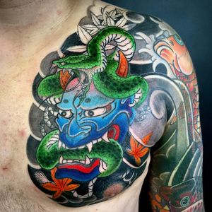 A stunning illustrative tattoo featuring a snake, flower, hannya, leaf, and cloud motifs, expertly created by Kiko Lopes.
