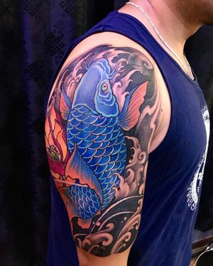 Avi's illustrative tattoo combines intricate filigree details with traditional Japanese motifs of koi fish, waves, and flowers.