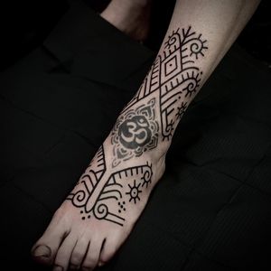 Elegant design featuring intricate patterns and lines by tattoo artist Lamat. Perfect for those seeking a unique foot tattoo.