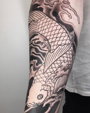 Immerse yourself in the beauty of traditional Japanese art with this stunning, illustrative koi fish and waves tattoo by Kiko Lopes.
