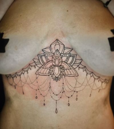 Elegant blackwork design featuring a beautiful lotus flower, created by talented artist Frankie Brown.