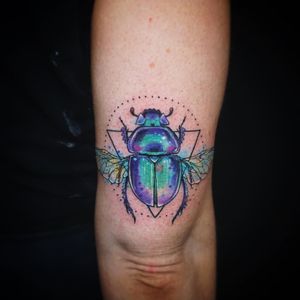 Vibrant watercolor beetle design on upper arm by Aygul, combining geometric shapes for a unique and artistic look.