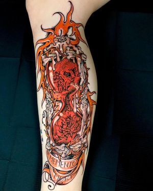 Unique upper arm tattoo by Matthew Ono featuring Japanese small lettering, a skull, and an hourglass motif.