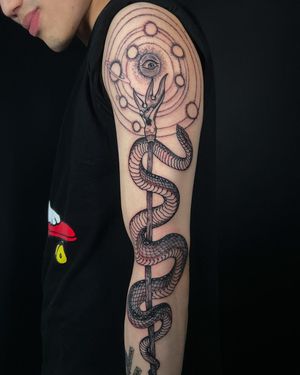 Experience the intricacy of black and gray dotwork by Fernando Joergensen in this stunning snake and pattern design.