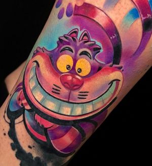Illustrative anime style tattoo of a Cheshire cat on the lower leg by Cloto.tattoos.