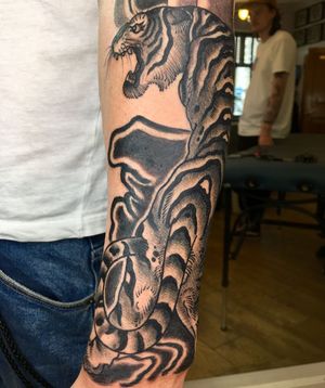 Intricate blackwork illustration of a fierce tiger by artist Kiko Lopes, perfect for the forearm.