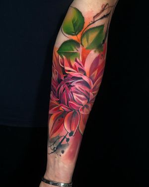 Beautiful illustrative flower design on forearm by Cloto.tattoos, featuring vibrant watercolor elements.