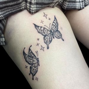 Letitia Mortimer's black and gray butterfly tattoo beautifully adorns the upper leg with a touch of elegance and grace.