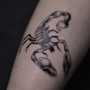Get inked with a fierce scorpion design in traditional black and gray style by tattoo artist Luca Salzano. Stand out with this striking forearm tattoo.