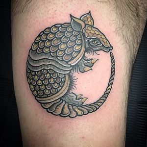 Get a vibrant new school armadillo tattoo on your arm by the talented artist Matthew Ono. Stand out with this unique and eye-catching design.