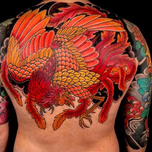 Experience the fiery rebirth with this stunning Japanese phoenix tattoo on your upper back. Expertly crafted by Kiko Lopes.