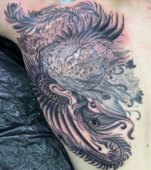 Get a stunning blackwork phoenix tattoo on your ribs by the talented artist Kiko Lopes. Embrace the rebirth and power symbolized by this mythical creature.