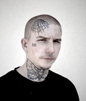 Elegant side face tattoo featuring a delicate spider and intricate web design, expertly executed with fine line technique by artist Lamat.