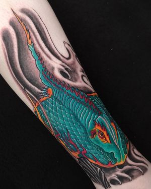 Capture the beauty of Japanese art with a stunning fish motif tattoo on your forearm by Fernando Joergensen.