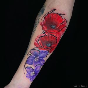 Vibrant watercolor flower tattoo on the forearm by artist Marie Terry. A beautiful and colorful addition to your body art.