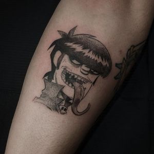 Get a sleek black and gray anime rendering of Murdoc on your forearm by tattoo artist Luca Salzano.